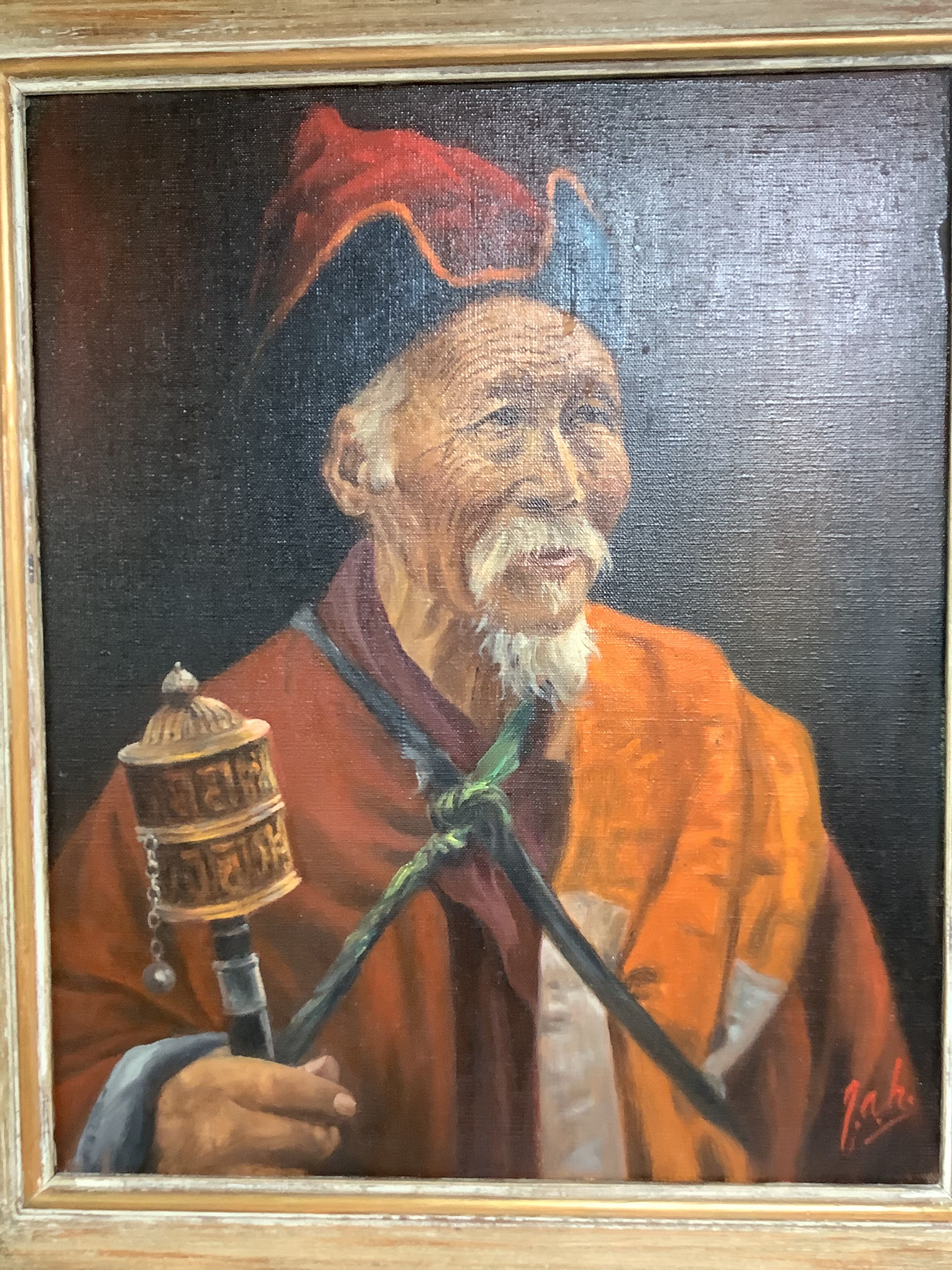 A pair of oils on canvas of Tibetan figures holding prayer wheels, 44.5 x 36cm